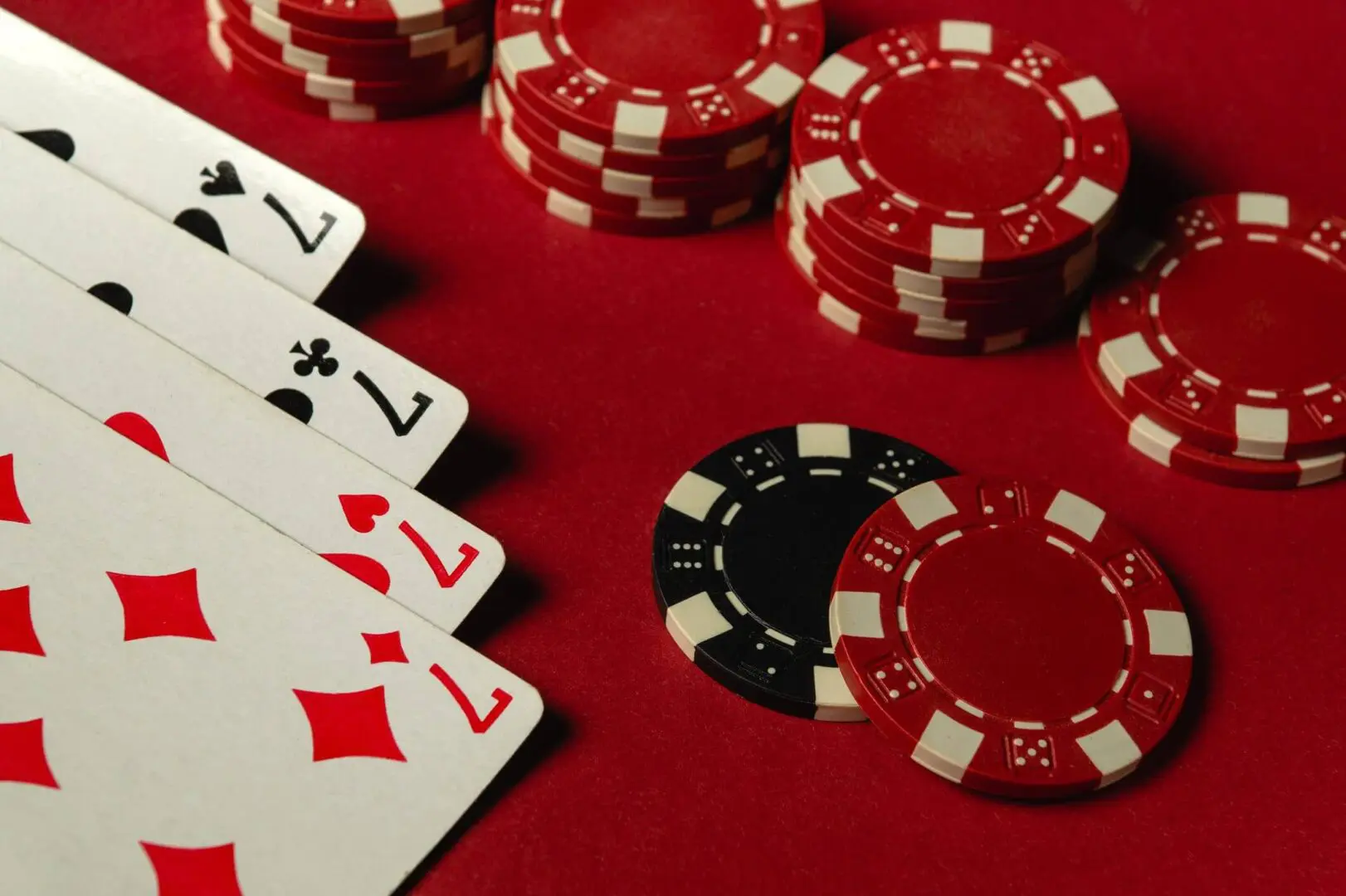 Playing cards and poker chips on table.